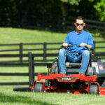 Man in blue shirt and sunglasses using Toro Titan